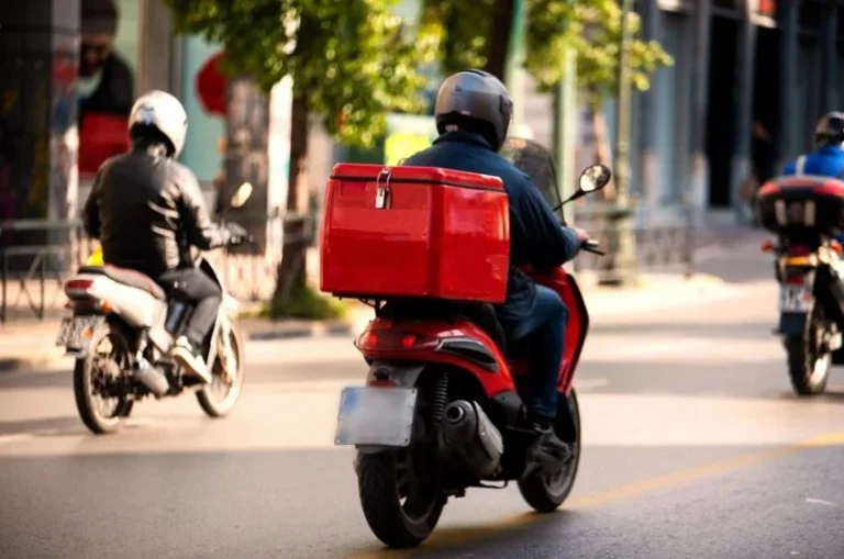 A delivery rider navigating traffic in an African city, where last-mile delivery costs run far higher than the global average