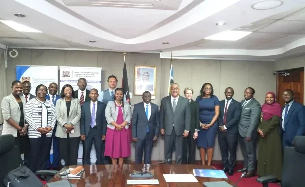 Kenyan professionals at a digital innovation hub with computers and training materials, representing the DigiKen programme